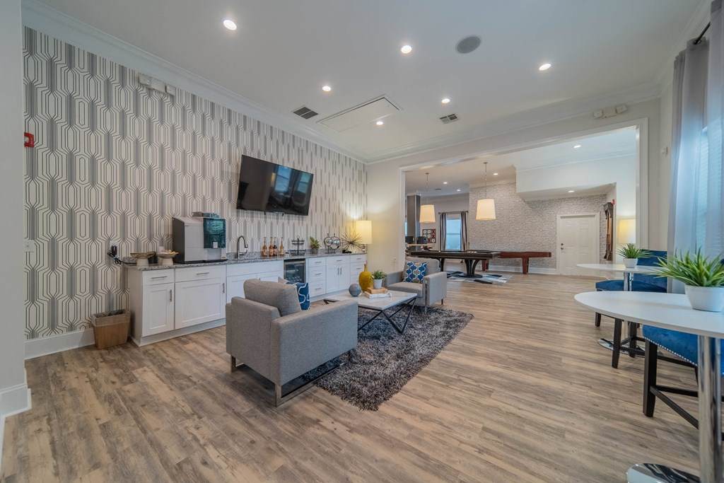 a living room with couches and a table and a television